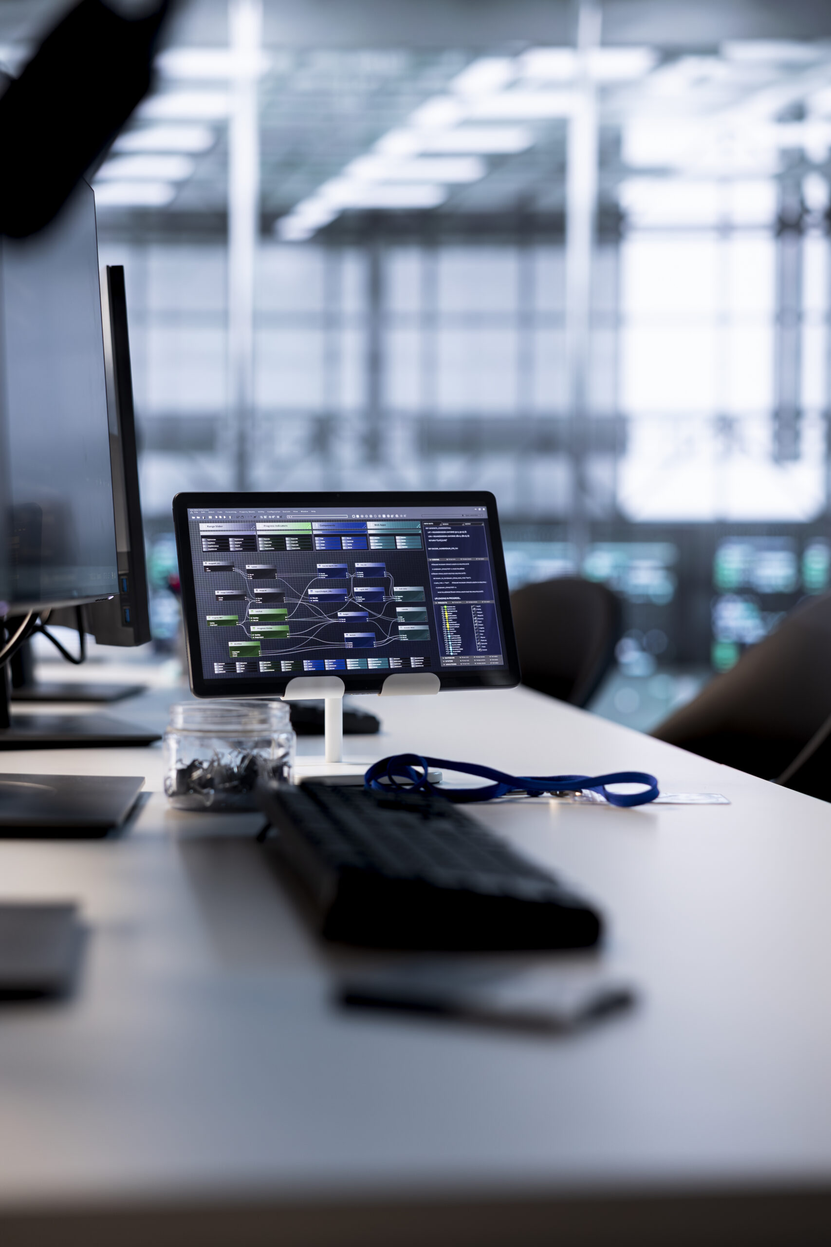 Code running on computer screens and tablet in empty data center